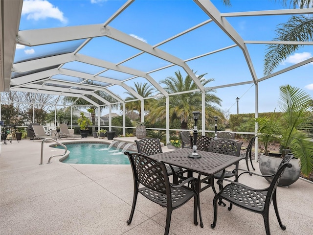 view of swimming pool with pool water feature, a lanai, and a patio