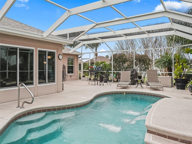 view of swimming pool featuring pool water feature, a lanai, and a patio area