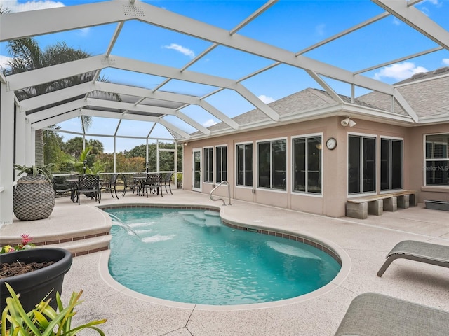 view of pool with a patio, a lanai, and pool water feature