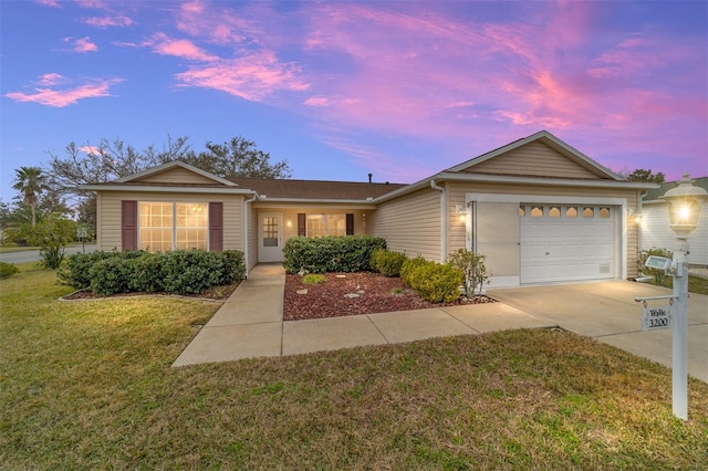 ranch-style house with a garage and a lawn