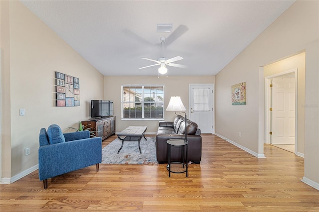 living room featuring vaulted ceiling, ceiling fan, and light wood-type flooring