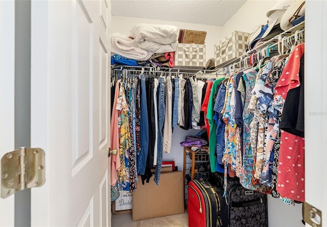 walk in closet with tile patterned flooring