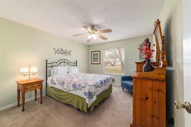 bedroom featuring ceiling fan, carpet flooring, and a textured ceiling