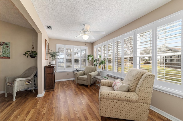 sunroom with a wealth of natural light and ceiling fan