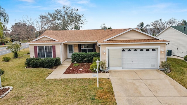 ranch-style home featuring a garage, a front yard, and central AC unit