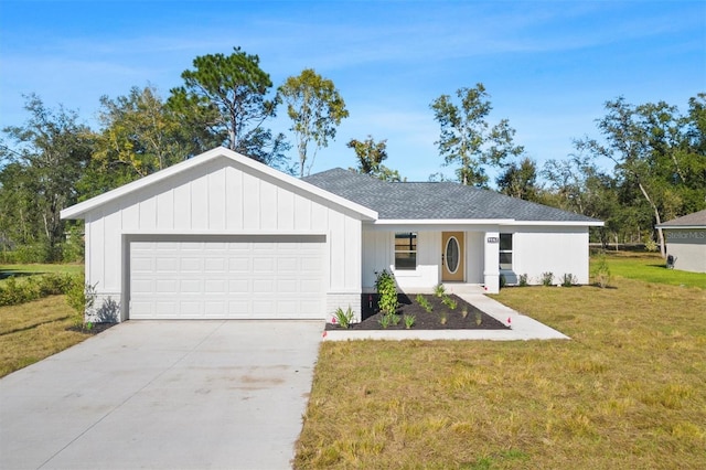 view of front of property with a front lawn and a garage