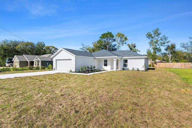 ranch-style home featuring a front yard and a garage