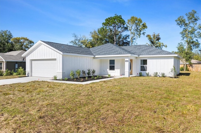 view of front of home with a garage and a front lawn