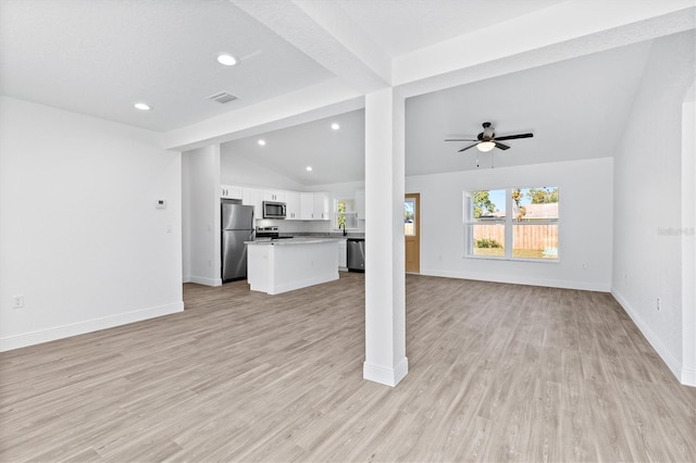 unfurnished living room featuring vaulted ceiling, ceiling fan, light hardwood / wood-style floors, and sink