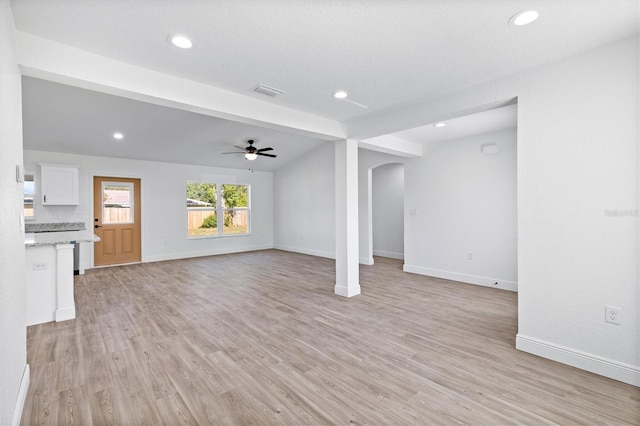 unfurnished living room featuring ceiling fan, beam ceiling, and light wood-type flooring