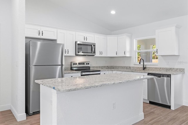 kitchen with white cabinets, appliances with stainless steel finishes, and a kitchen island