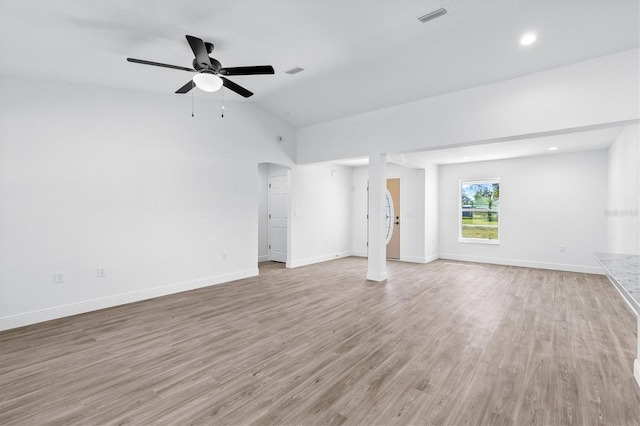 unfurnished living room featuring vaulted ceiling, ceiling fan, and light hardwood / wood-style flooring