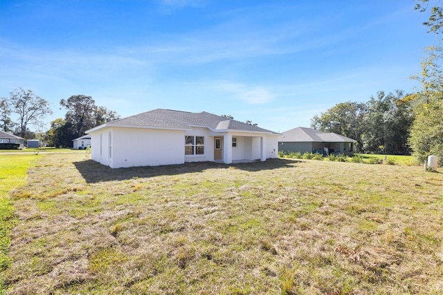 rear view of house with a lawn