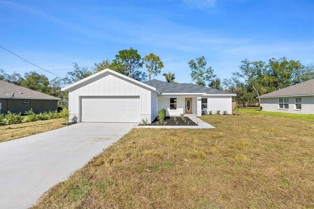 view of front of home with a front yard and a garage