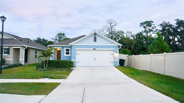 view of front of property with a front yard and a garage