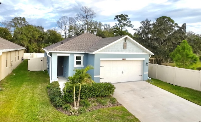 view of front of home with a front yard and a garage