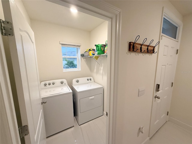 laundry room featuring light tile patterned floors and washing machine and dryer