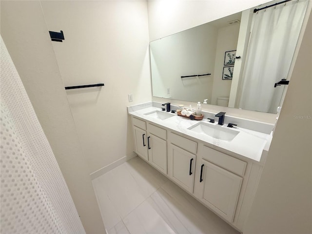 bathroom featuring toilet, a shower with shower curtain, tile patterned floors, and vanity