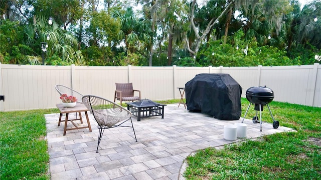 view of patio / terrace with an outdoor fire pit and grilling area