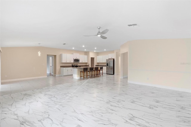 unfurnished living room with ceiling fan