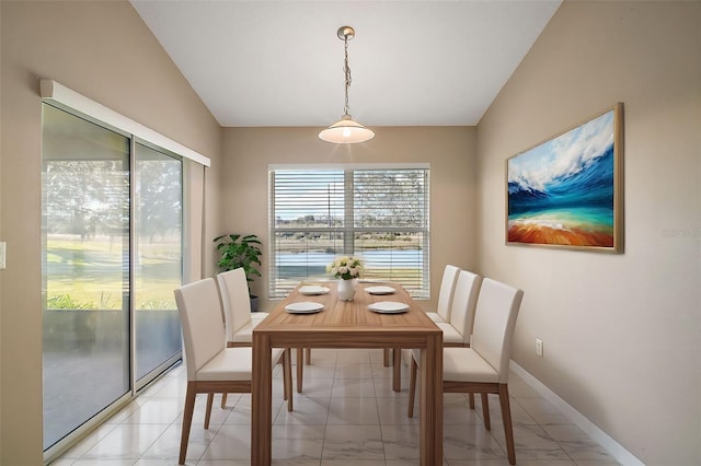 dining space featuring lofted ceiling