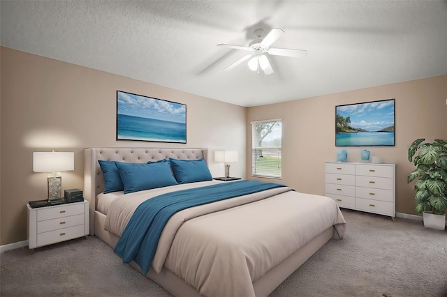 bedroom with ceiling fan, light colored carpet, and a textured ceiling