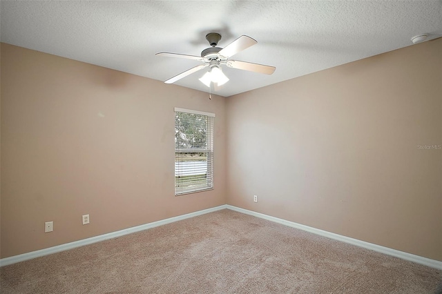 carpeted spare room featuring a textured ceiling and ceiling fan