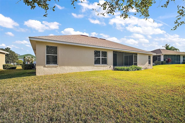 rear view of property with a lawn