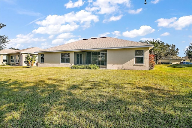 rear view of property featuring a yard