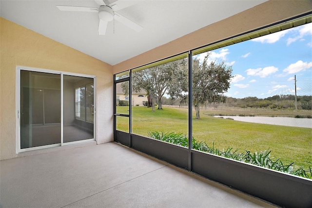 unfurnished sunroom with vaulted ceiling, ceiling fan, and a water view