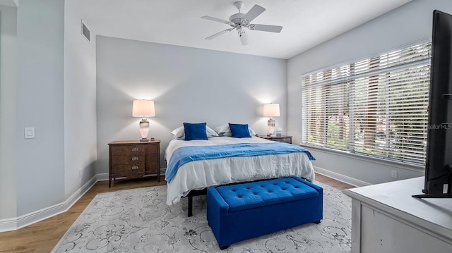 bedroom with ceiling fan and light hardwood / wood-style floors