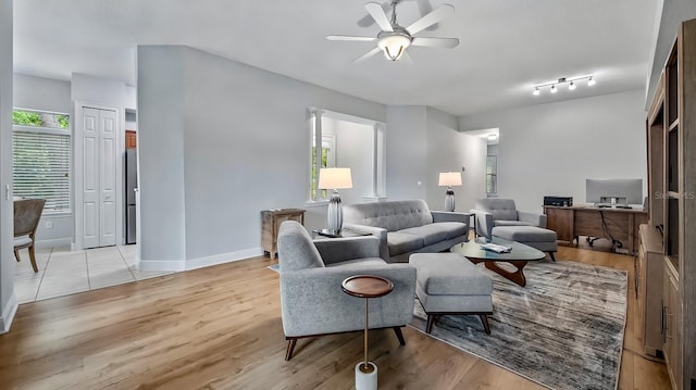 living room featuring ceiling fan and light wood-type flooring