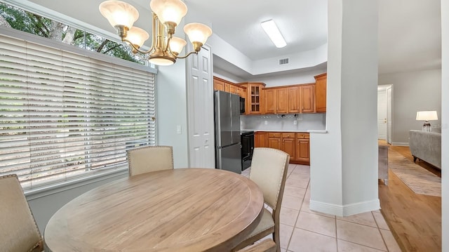 tiled dining area with a notable chandelier