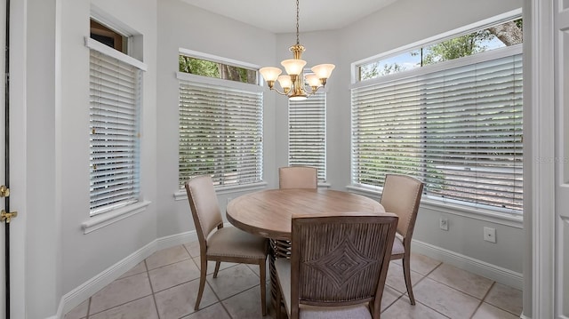 dining area featuring light tile patterned floors and an inviting chandelier