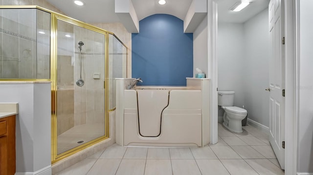 bathroom with vaulted ceiling, toilet, a shower with door, and tile patterned flooring