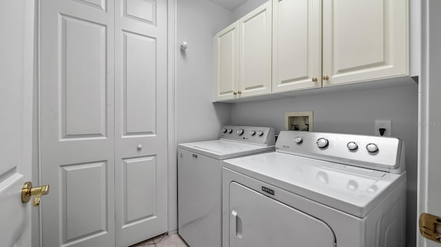 laundry area with cabinets and washing machine and clothes dryer