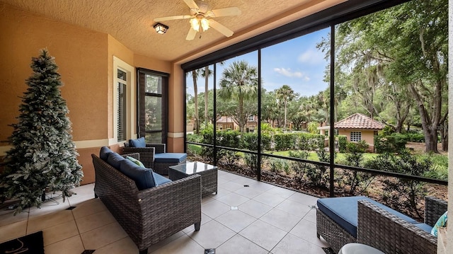 sunroom featuring ceiling fan