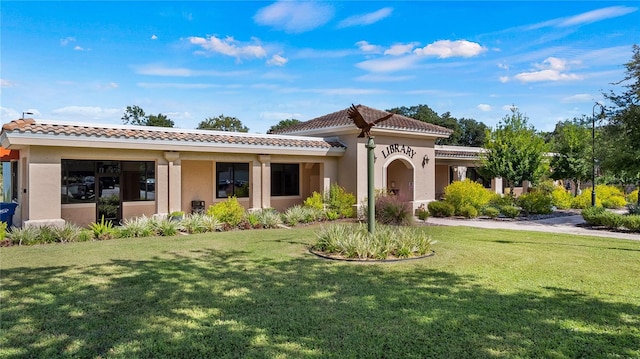 mediterranean / spanish house with a front yard