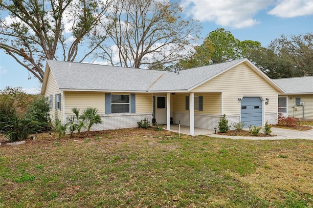 ranch-style house featuring a front yard and a garage