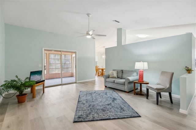 living room with light wood-type flooring, ceiling fan, and high vaulted ceiling