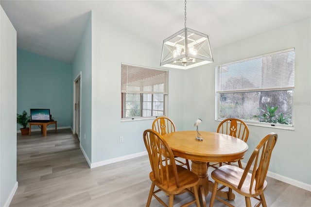 dining area featuring an inviting chandelier, light hardwood / wood-style floors, and plenty of natural light