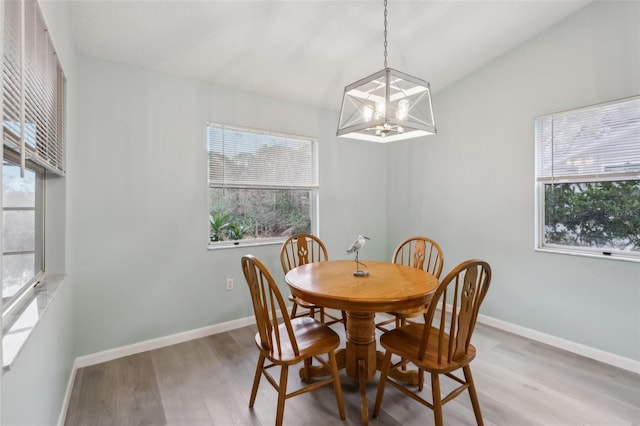 dining room featuring hardwood / wood-style floors and a notable chandelier