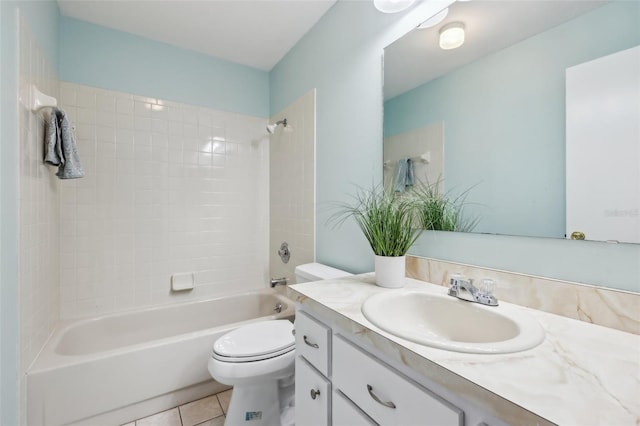 full bathroom featuring toilet, tiled shower / bath combo, tile patterned floors, and vanity