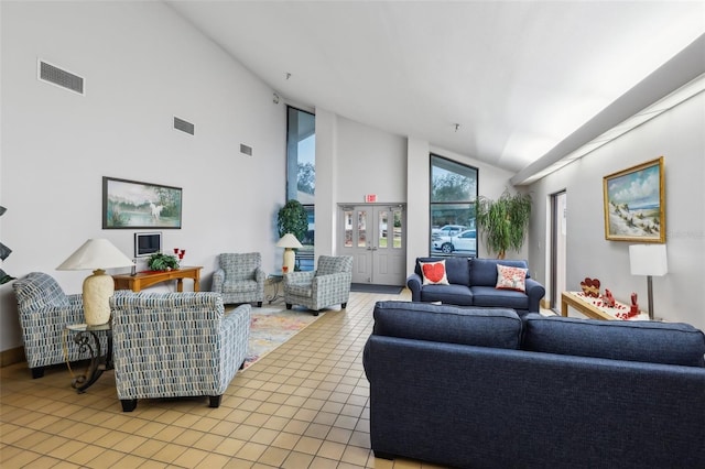 tiled living room with high vaulted ceiling