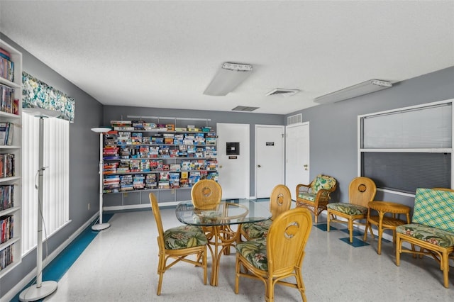 dining room with a textured ceiling