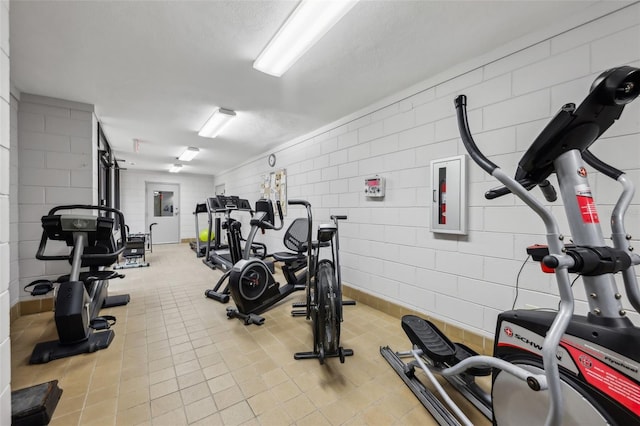 exercise room featuring a textured ceiling and electric panel