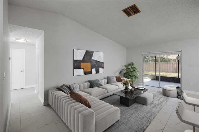 living room with a textured ceiling and vaulted ceiling