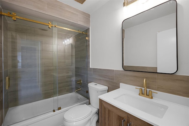 full bathroom with toilet, tasteful backsplash, tile walls, shower / bath combination with glass door, and vanity