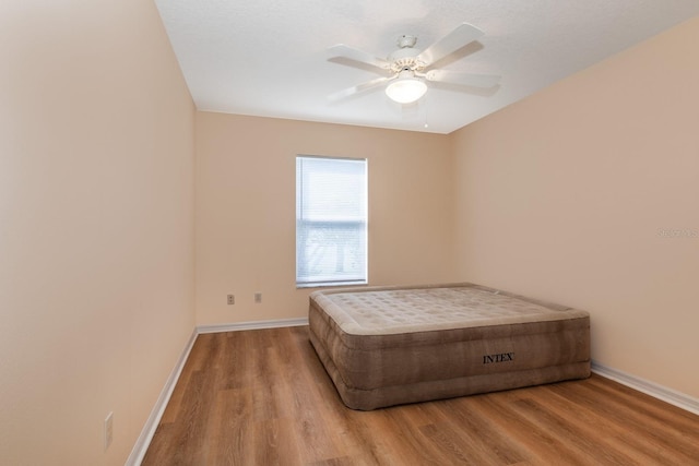 unfurnished bedroom with ceiling fan, light hardwood / wood-style floors, and a textured ceiling