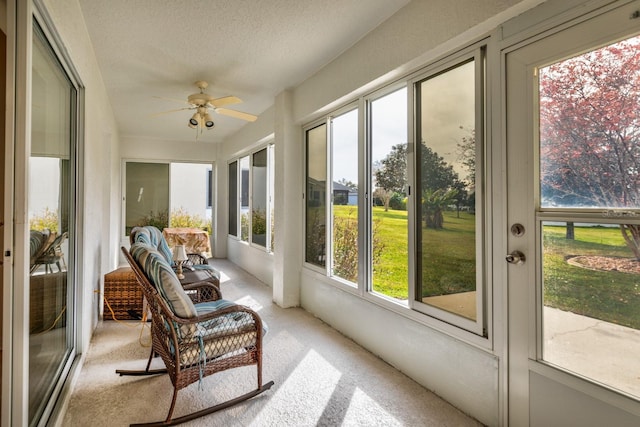 sunroom / solarium featuring ceiling fan